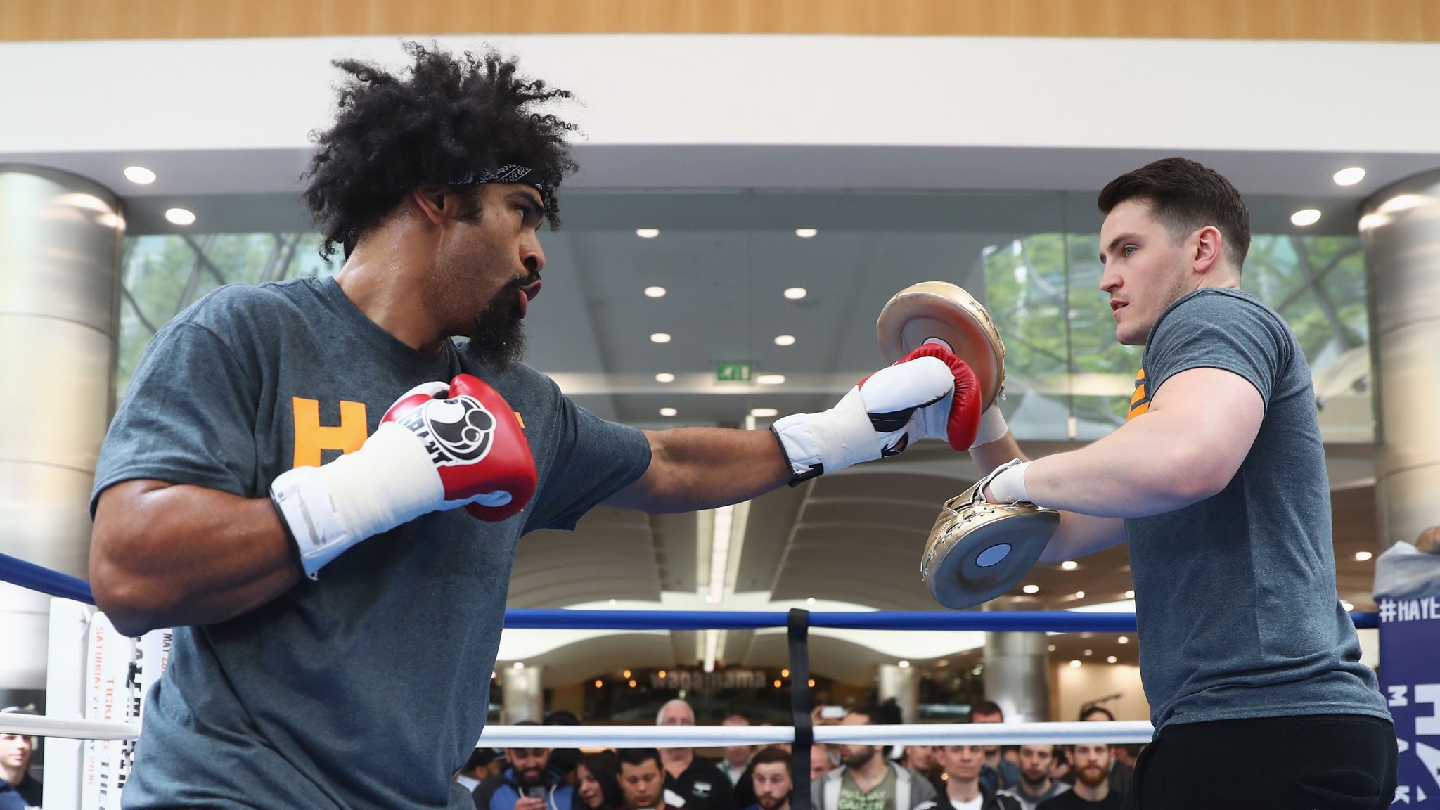 Trainer Shane Mcguire in the ring training with a boxer.